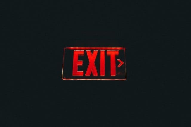 A red exit sign on a wall. 